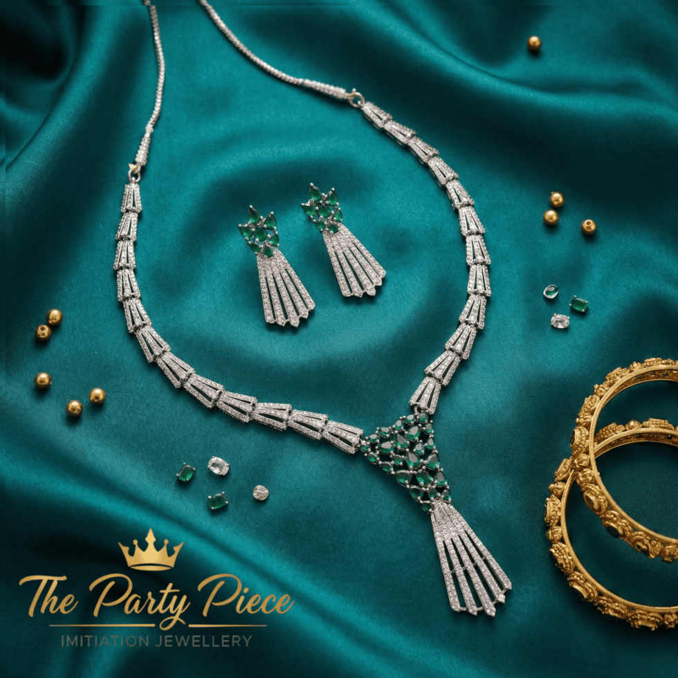 Green Crescent Floral Green American Emerald Tassel American Diamond Necklace Set with white background by The Party Piece brand. best imitation jewelery brand in india